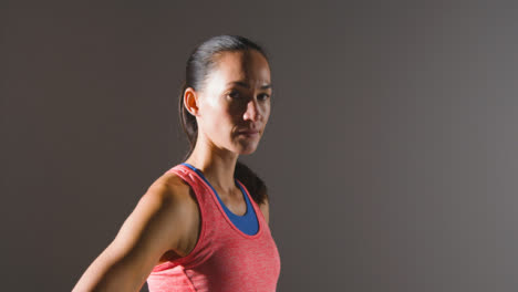 Tracking-Shot-of-Young-Woman-Looking-at-Camera-at-Gym