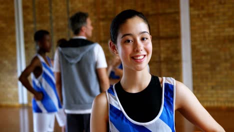 High-school-girl-standing-with-basketball-in-the-court-4k